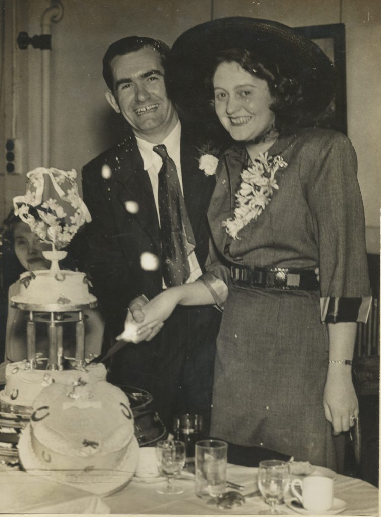 A couple cutting their cake on their wedding day